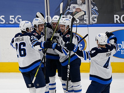 Mar 9, 2021; Toronto, Ontario, CAN; Winnipeg Jets defenseman Josh Morrissey (44) gets congratulated on his goal against the Toronto Maple Leafs during the second period at Scotiabank Arena. Mandatory Credit: John E. Sokolowski-USA TODAY Sports