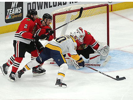 Mar 27, 2021; Chicago, Illinois, USA; Nashville Predators center Colton Sissons (10) moves in on Chicago Blackhawks goaltender Kevin Lankinen (32) during the second period at the United Center. Mandatory Credit: Dennis Wierzbicki-USA TODAY Sports