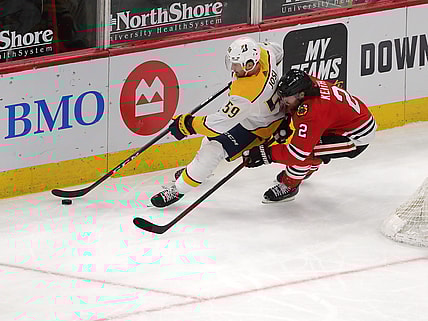 Mar 27, 2021; Chicago, Illinois, USA; Chicago Blackhawks defenseman Duncan Keith (2) and Nashville Predators defenseman Roman Josi (59) chase the puck behind the net during the third period at the United Center. Mandatory Credit: Dennis Wierzbicki-USA TODAY Sports
