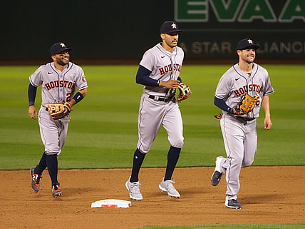 Apr 1, 2021; Oakland, California, USA; Houston Astros second baseman Jose Altuve (27), shortstop Carlos Correa (1) and left fielder Chas McCormick (6) celebrate after a win against the Oakland Athletics at RingCentral Coliseum. Mandatory Credit: Kelley L Cox-USA TODAY Sports