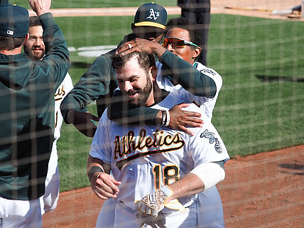 Apr 7, 2021; Oakland, California, USA; Oakland Athletics left fielder Tony Kemp (5) celebrates with first baseman Mitch Moreland (18) after Moreland hit an RBI single for a walk-off win against the Los Angeles Dodgers in the tenth inning at RingCentral Coliseum. Mandatory Credit: Kelley L Cox-USA TODAY Sports