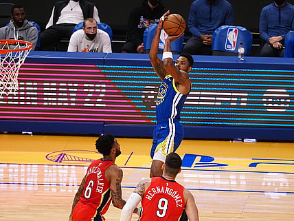 May 14, 2021; San Francisco, California, USA; Golden State Warriors guard-forward Kent Bazemore (26) scores a basket above New Orleans Pelicans guard Nickeil Alexander-Walker (6) and center-forward Willy Hernangomez (9) during the second quarter at Chase Center. Mandatory Credit: Kelley L Cox-USA TODAY Sports