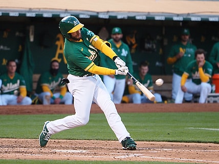 Jun 10, 2021; Oakland, California, USA; Oakland Athletics designated hitter Jed Lowrie (8) hits a home run against the Kansas City Royals during the fourth inning at RingCentral Coliseum. Mandatory Credit: Kelley L Cox-USA TODAY Sports