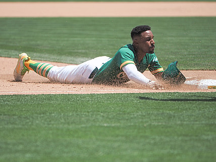 Jun 16, 2021; Oakland, California, USA; Oakland Athletics second baseman Tony Kemp (5) slides to third base against the Los Angeles Angels during the fifth inning at RingCentral Coliseum. Mandatory Credit: Kelley L Cox-USA TODAY Sports