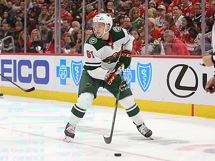 Dec 15, 2019; Chicago, IL, USA; Minnesota Wild defenseman Brennan Menell (61) with the puck during the first period against the Chicago Blackhawks at United Center. Mandatory Credit: Dennis Wierzbicki-USA TODAY Sports