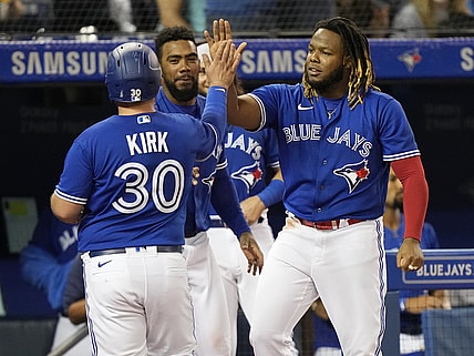 Sep 13, 2021; Toronto, Ontario, CAN; Toronto Blue Jays first baseman Vladimir Guerrero Jr (27) congratulates catcher Alejandro Kirk (30) on scoring against the Tampa Bay Rays in the fourth inning at Rogers Centre. Mandatory Credit: John E. Sokolowski-USA TODAY Sports