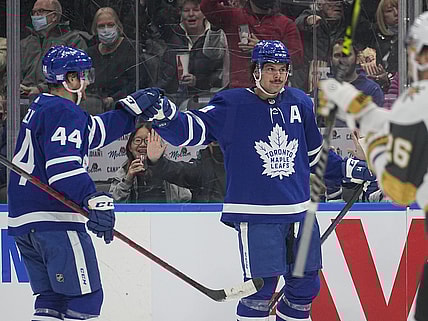 Nov 2, 2021; Toronto, Ontario, CAN; Toronto Maple Leafs defenseman Morgan Rielly (44) congratulates Toronto Maple Leafs forward Auston Matthews (34) on his first goal against the Vegas Golden Knights during the second period at Scotiabank Arena. Mandatory Credit: John E. Sokolowski-USA TODAY Sports