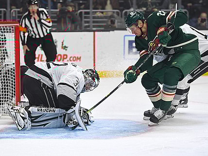 Dec 11, 2021; Los Angeles, California, USA;  Los Angeles Kings goaltender Jonathan Quick (32) blocks the puck as Minnesota Wild center Nick Bjugstad (27) tried to poke it under his glove in the first period of the game at Staples Center. Mandatory Credit: Jayne Kamin-Oncea-USA TODAY Sports