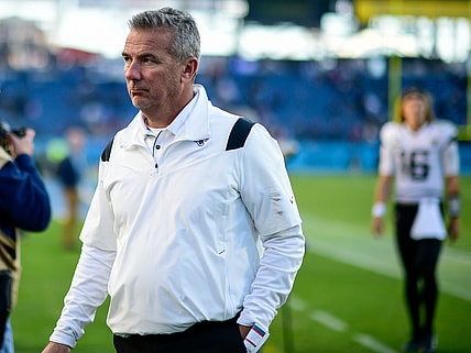 Dec 12, 2021; Nashville, Tennessee, USA;  Jacksonville Jaguars head coach Urban Meyer walks from the field after the game as quarterback Trevor Lawrence (16) follows against the Tennessee Titans at Nissan Stadium. Mandatory Credit: Steve Roberts-USA TODAY Sports