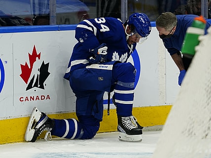 Feb 7, 2022; Toronto, Ontario, CAN; A Toronto Maple Leafs trainer checks on an injured forward Auston Matthews (34) during the third period against the Carolina Hurricanes at Scotiabank Arena. Mandatory Credit: John E. Sokolowski-USA TODAY Sports