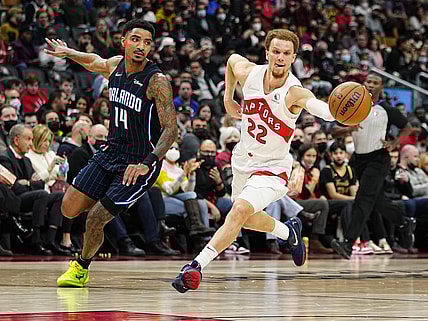 Mar 4, 2022; Toronto, Ontario, CAN; Toronto Raptors guard Malachi Flynn (22) drives to the basket against Orlando Magic guard Gary Harris (14) during the first half at Scotiabank Arena. Mandatory Credit: John E. Sokolowski-USA TODAY Sports