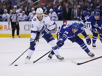 Apr 4, 2019; Toronto, Ontario, CAN; Tampa Bay Lightning forward Steven Stamkos (91) moves the puck against Toronto Maple Leafs forward Auston Matthews (34) at Scotiabank Arena. Tampa Bay defeated Toronto. Mandatory Credit: John E. Sokolowski-USA TODAY Sports
