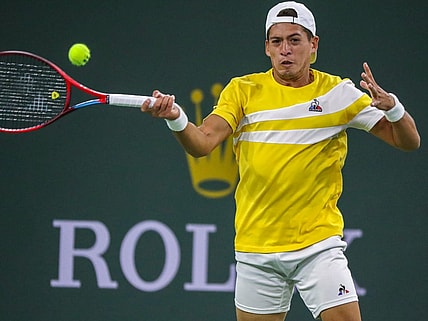 Sebastian Baez of Argentina returns the ball to Nick Kyrgios of Australia during round one of the BNP Paribas Open at the Indian Wells Tennis Garden in Indian Wells, Calif., Thursday, March 10, 2022.