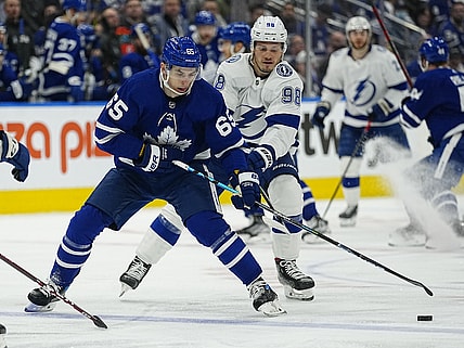 May 4, 2022; Toronto, Ontario, CAN; Tampa Bay Lightning defenseman Mikhail Sergachev (98) tries to knock the puck away from Toronto Maple Leafs forward Ilya Mikheyev (65) during the first period of game two of the first round of the 2022 Stanley Cup Playoffs at Scotiabank Arena. Mandatory Credit: John E. Sokolowski-USA TODAY Sports