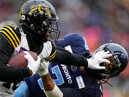 Dec 5, 2021; Toronto, Ontario, CAN; Hamilton Tiger-Cats wide receiver Brandon Banks (16) and Toronto Argonauts defensive back Jalen Collins (7) after a pass reception during the Canadian Football League Eastern Conference Final game at BMO Field. Mandatory Credit: John E. Sokolowski-USA TODAY Sports