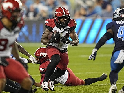 Aug 20, 2022; Toronto, Ontario, CAN; Calgary Stampeders running back Dedrick Mills (34) runs the football against the Toronto Argonauts during the second half at BMO Field. Mandatory Credit: John E. Sokolowski-USA TODAY Sports