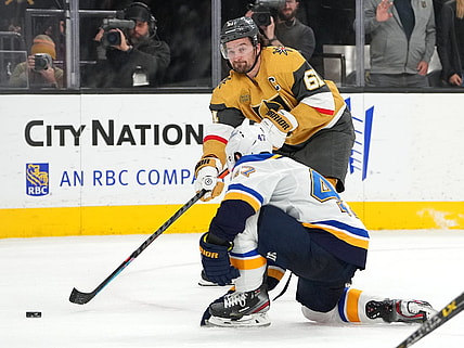 Dec 23, 2022; Las Vegas, Nevada, USA; Vegas Golden Knights right wing Mark Stone (61) sends a pass ahead of St. Louis Blues defenseman Torey Krug (47) during an overtime period at T-Mobile Arena. Mandatory Credit: Stephen R. Sylvanie-USA TODAY Sports