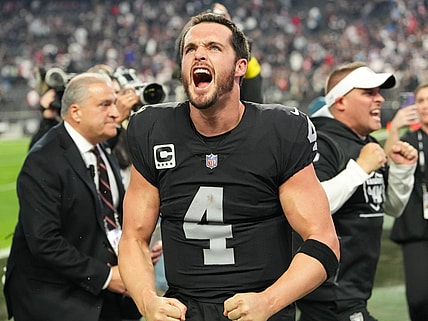 Dec 18, 2022; Paradise, Nevada, USA; Las Vegas Raiders quarterback Derek Carr (4) and Raiders head coach Josh McDaniels celebrate after the Raiders defeated the New England Patriots 30-24 at Allegiant Stadium. Mandatory Credit: Stephen R. Sylvanie-USA TODAY Sports