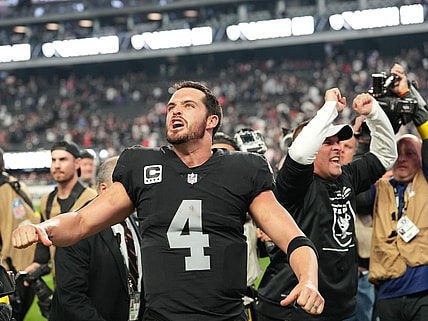 Dec 18, 2022; Paradise, Nevada, USA; Las Vegas Raiders quarterback Derek Carr (4) and Raiders head coach Josh McDaniels celebrate after the Raiders defeated the New England Patriots 30-24 at Allegiant Stadium. Mandatory Credit: Stephen R. Sylvanie-USA TODAY Sports
