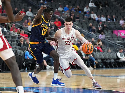 Mar 8, 2023; Las Vegas, NV, USA; Washington State Cougars forward Andrej Jakimovski (23) dribbles against California Golden Bears forward Kuany Kuany (13) during the second half at T-Mobile Arena. Mandatory Credit: Stephen R. Sylvanie-USA TODAY Sports