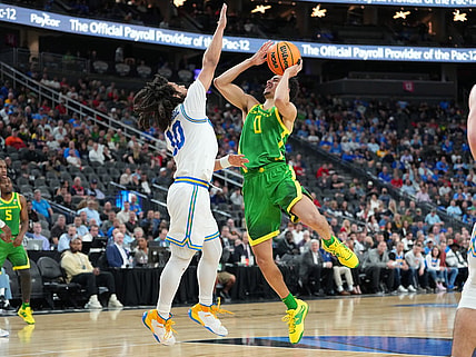 Mar 10, 2023; Las Vegas, NV, USA; Oregon Ducks guard Will Richardson (0) shoots against UCLA Bruins guard Tyger Campbell (10) during the first half at T-Mobile Arena. Mandatory Credit: Stephen R. Sylvanie-USA TODAY Sports