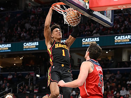 Dec 31, 2023; Washington, District of Columbia, USA;  Atlanta Hawks forward Jalen Johnson (1) dunks the ball as Washington Wizards center Mike Muscala (35) looks on during the first half at Capital One Arena. Mandatory Credit: James A. Pittman-USA TODAY Sports