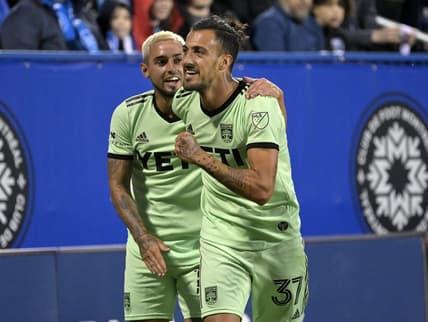 Jun 18, 2022; Montreal, Quebec, CAN; Austin FC forward Maximiliano Urruti (37) celebrates with teammate Austin FC midfielder Diego Fagundez (14) after scoring a goal against the CF Montreal during the second half at Stade Saputo. Mandatory Credit: Eric Bolte-USA TODAY Sports