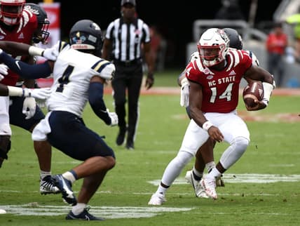Sep 10, 2022; Raleigh, North Carolina, USA; North Carolina State Wolfpack quarterback Jack Chambers (14) runs the ball during the second half against the Charleston Southern Buccaneers at Carter-Finley Stadium. Mandatory Credit: Rob Kinnan-USA TODAY Sports