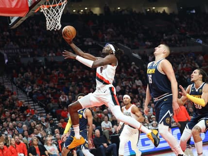Oct 24, 2022; Portland, Oregon, USA;  Portland Trail Blazers forward Jerami Grant (9) shoots over Denver Nuggets center Nikola Jokic (15) in the first half at Moda Center. Mandatory Credit: Jaime Valdez-USA TODAY Sports