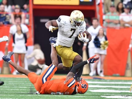 Oct 29, 2022; Syracuse, New York, USA; Notre Dame Fighting Irish running back Audric Estime (7) runs over Syracuse Orange defensive back Alijah Clark (5) in the second quarter at JMA Wireless Dome. Mandatory Credit: Mark Konezny-USA TODAY Sports