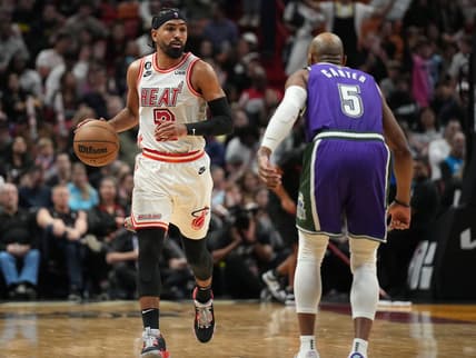 Jan 14, 2023; Miami, Florida, USA; Miami Heat guard Gabe Vincent (2) brings the ball up the court against Milwaukee Bucks guard Jevon Carter (5) during the second  half at Miami-Dade Arena. Mandatory Credit: Jim Rassol-USA TODAY Sports