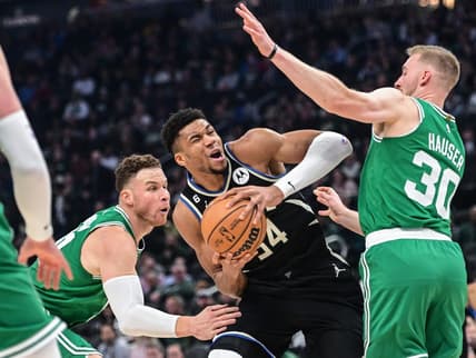 Feb 14, 2023; Milwaukee, Wisconsin, USA;  Milwaukee Bucks forward Giannis Antetokounmpo (34) looks for a shot between Boston Celtics forward Blake Griffin (91) and forward Sam Hauser (30) in the first quarter at Fiserv Forum. Mandatory Credit: Benny Sieu-USA TODAY Sports