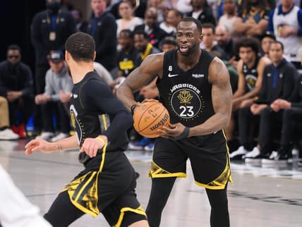 Mar 28, 2023; San Francisco, California, USA; Golden State Warriors center Draymond Green (23) controls the ball as he looks towards guard Stephen Curry (30) during the second quarter against the New Orleans Pelicans at Chase Center. Mandatory Credit: Kelley L Cox-USA TODAY Sports