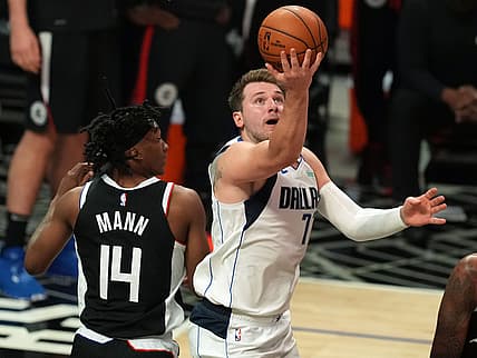 Jun 6, 2021; Los Angeles, California, USA; Dallas Mavericks guard Luka Doncic (77) moves to the basket against Los Angeles Clippers guard Terance Mann (14) during the second half in game seven of the first round of the 2021 NBA Playoffs. at Staples Center. Mandatory Credit: Kirby Lee-USA TODAY Sports