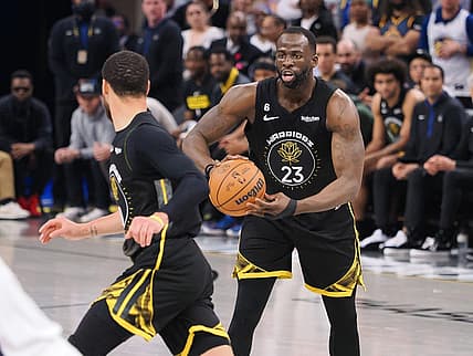Mar 28, 2023; San Francisco, California, USA; Golden State Warriors center Draymond Green (23) controls the ball as he looks towards guard Stephen Curry (30) during the second quarter against the New Orleans Pelicans at Chase Center. Mandatory Credit: Kelley L Cox-USA TODAY Sports