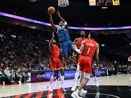 Feb 13, 2024; Portland, Oregon, USA;  Minnesota Timberwolves guard Anthony Edwards (5) shoots the ball over Portland Trail Blazers forward Jerami Grant (9), center Deandre Ayton (2), and guard Anfernee Simons (1) in the second quarter at Moda Center. Mandatory Credit: Jaime Valdez-USA TODAY Sports