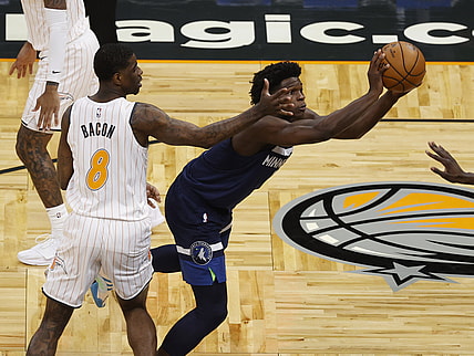 May 9, 2021; Orlando, Florida, USA; Minnesota Timberwolves forward Anthony Edwards (1) passes the ball as Orlando Magic guard Dwayne Bacon (8) defends during the first half at Amway Center. Mandatory Credit: Kim Klement-USA TODAY Sports