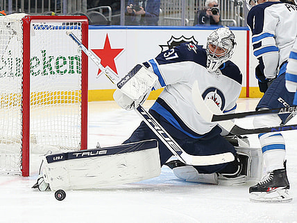 Mar 11, 2022; Elmont, New York, USA; Winnipeg Jets goaltender Connor Hellebuyck (37) makes a save against the New York Islanders during the second period at UBS Arena. Mandatory Credit: Andy Marlin-USA TODAY Sports