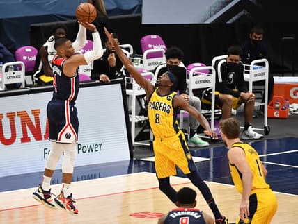 Mar 29, 2021; Washington, District of Columbia, USA; Washington Wizards guard Russell Westbrook (4) shoots the ball over Indiana Pacers forward Justin Holiday (8) during the fourth quarter at Capital One Arena. Mandatory Credit: Brad Mills-USA TODAY Sports