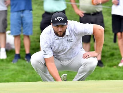 Aug 20, 2021; Jersey City, New Jersey, USA; Jon Rahm lines up his putt on the 16th green during the second round of The Northern Trust golf tournament at the Liberty National Golf Club. Mandatory Credit: Mark Konezny-USA TODAY Sports