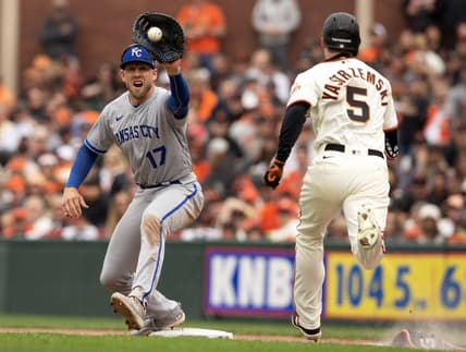 Apr 7, 2023; San Francisco, California, USA; Kansas City Royals first baseman Hunter Dozier (17) takes the relay in time to retire San Francisco Giants center fielder Mike Yastrzemski (5) on a bunt attempt during the sixth inning at Oracle Park. Mandatory Credit: D. Ross Cameron-USA TODAY Sports