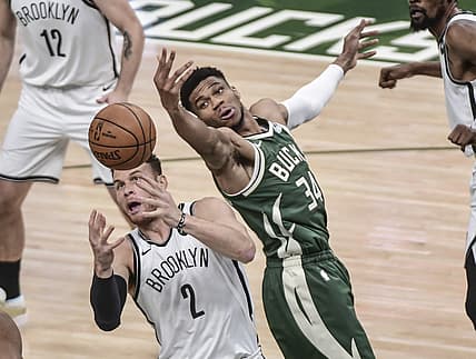 Jun 10, 2021; Milwaukee, Wisconsin, USA; Milwaukee Bucks forward Giannis Antetokounmpo (34) and Brooklyn Nets forward Blake Griffin (2) reach for a rebound in the first quarter during game three in the second round of the 2021 NBA Playoffs at Fiserv Forum. Mandatory Credit: Benny Sieu-USA TODAY Sports