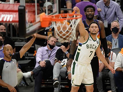 Jul 6, 2021; Phoenix, Arizona, USA; Milwaukee Bucks guard Bryn Forbes (7) makes a three point basket against the Phoenix Suns during the second half in game one of the 2021 NBA Finals at Phoenix Suns Arena. Mandatory Credit: Joe Camporeale-USA TODAY Sports