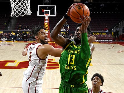 Jan 15, 2022; Los Angeles, California, USA; Oregon Ducks forward Quincy Guerrier (13) grabs a rebound in front of USC Trojans forward Isaiah Mobley (3) in the second half at Galen Center. Mandatory Credit: Jayne Kamin-Oncea-USA TODAY Sports