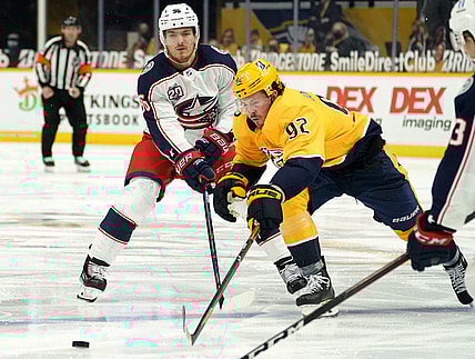 Feb 27, 2021; Nashville, Tennessee, USA;  Nashville Predators center Ryan Johansen (92) and Columbus Blue Jackets center Jack Roslovic (96) fight for the puck during the third period at Bridgestone Arena. Mandatory Credit: Steve Roberts-USA TODAY Sports