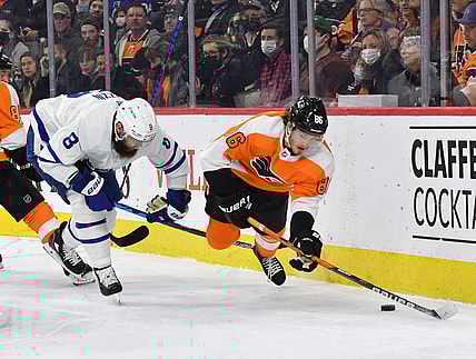 Nov 10, 2021; Philadelphia, Pennsylvania, USA; Philadelphia Flyers left wing Joel Farabee (86) is tripped up by Toronto Maple Leafs defenseman Jake Muzzin (8) during the first period at Wells Fargo Center. Mandatory Credit: Eric Hartline-USA TODAY Sports