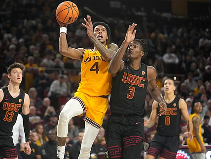 ASU Sun Devil guard Desmond Cambridge Jr. (4) shoots the ball over USC Trojans forward Vincent Iwuchukwu (3) at Desert Financial Arena in Tempe on Jan. 21, 2023.

Basketball Usc Asu Usc At Arizona State