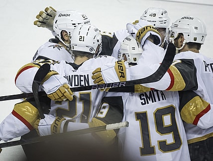 Vegas Golden Knights' Reilly Smith (19) celebrates his game-winning goal with teammates during overtime in an NHL hockey game against the Calgary Flames in Calgary, Alberta, Saturday, April 5, 2025. (Jeff McIntosh/The Canadian Press via AP)