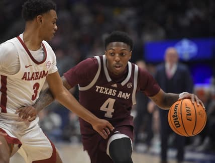 Mar 12, 2023; Nashville, TN, USA;  Texas A&M Aggies guard Wade Taylor IV (4) dribbles past Alabama Crimson Tide guard Rylan Griffen (3) during the first half at Bridgestone Arena. Mandatory Credit: Steve Roberts-USA TODAY Sports