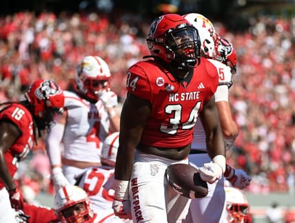 Sep 16, 2023; Raleigh, North Carolina, USA; North Carolina State Wolfpack running back Delbert Mimms III (34) celebrates a touchdown during the first half against the Virginia Military Institute Keydets at Carter-Finley Stadium. Mandatory Credit: Rob Kinnan-USA TODAY Sports